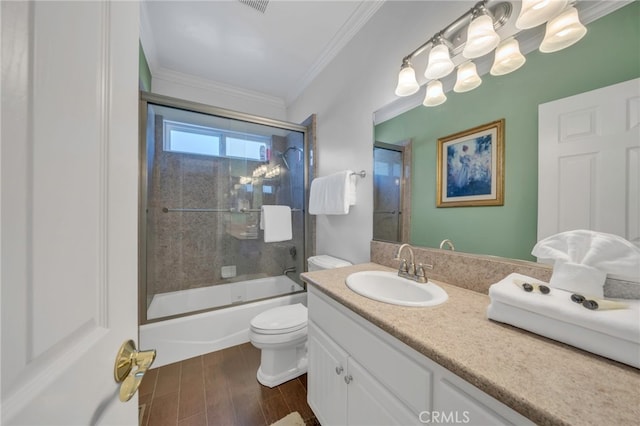 full bathroom featuring toilet, crown molding, enclosed tub / shower combo, and vanity