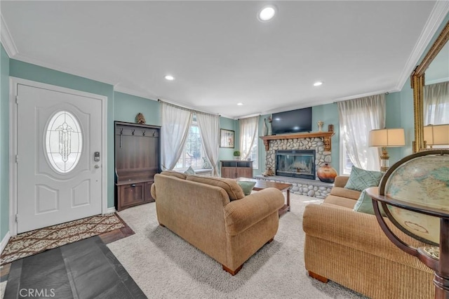 living room featuring crown molding and a fireplace