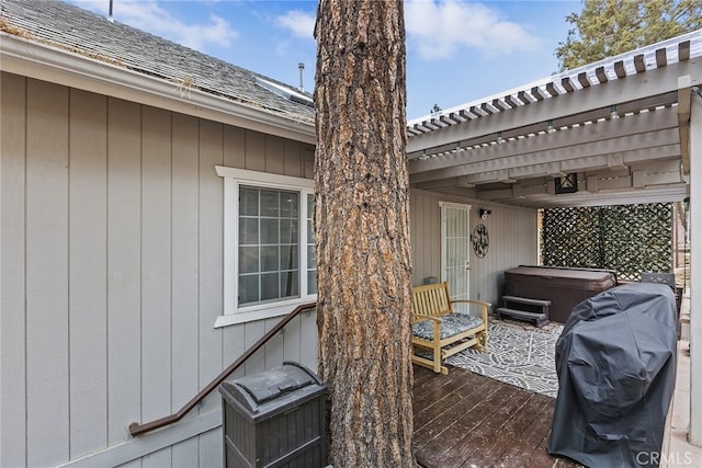 view of patio / terrace featuring grilling area, a deck, a pergola, and a hot tub