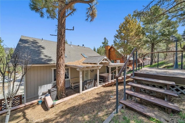 view of side of property with a wooden deck