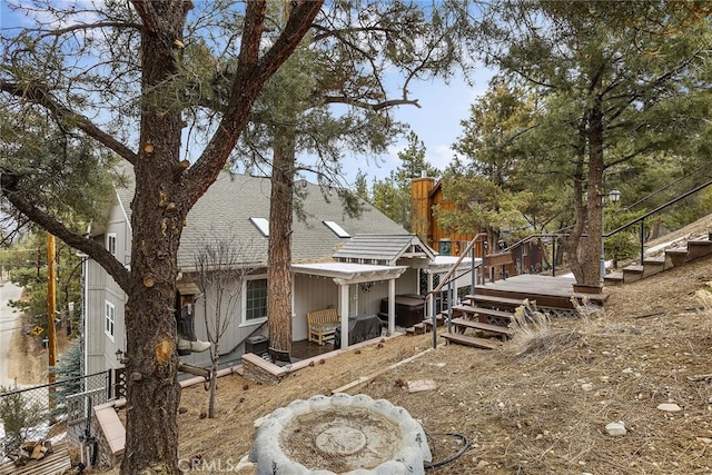 rear view of property featuring a deck