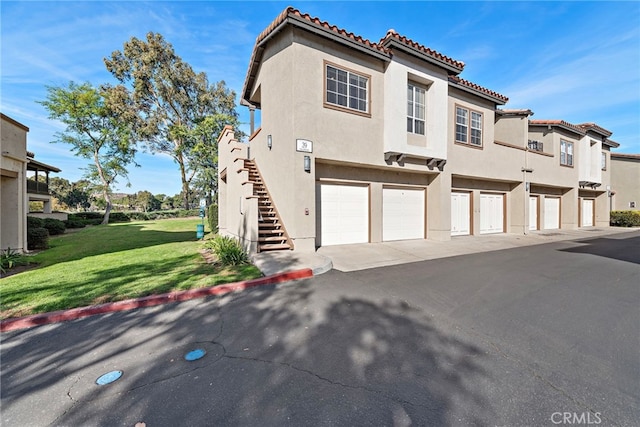 view of front of home with a garage and a front yard