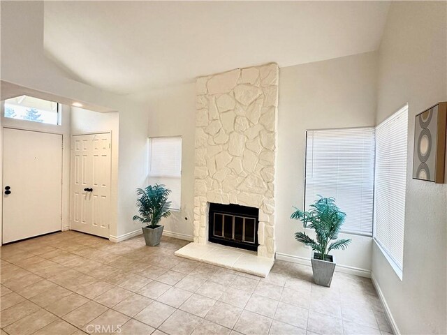 unfurnished living room with sink, light tile patterned floors, and crown molding