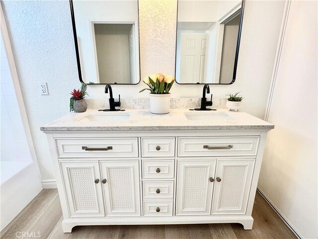 bathroom with hardwood / wood-style floors and vanity