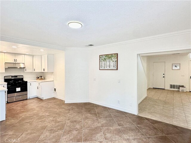 kitchen with appliances with stainless steel finishes, sink, light stone counters, and white cabinetry