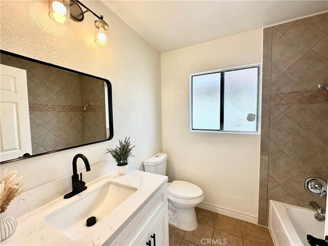 full bathroom with toilet, tiled shower / bath combo, tile patterned floors, and vanity