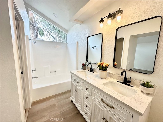 bathroom with vanity, shower / washtub combination, and hardwood / wood-style floors