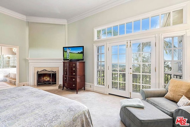 bedroom with access to exterior, a fireplace, connected bathroom, light carpet, and french doors