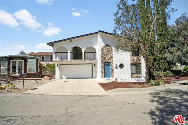 mediterranean / spanish home featuring a balcony and a garage