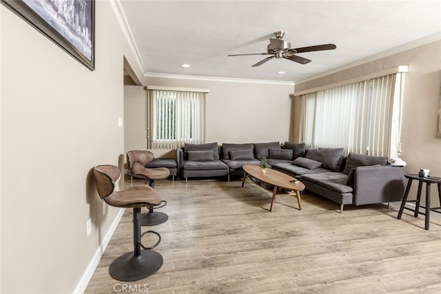 living room featuring ceiling fan, light hardwood / wood-style flooring, and crown molding