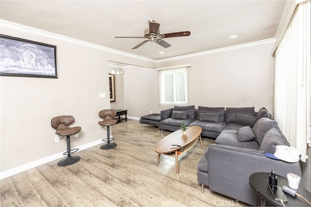 living room featuring ceiling fan with notable chandelier, crown molding, and hardwood / wood-style flooring