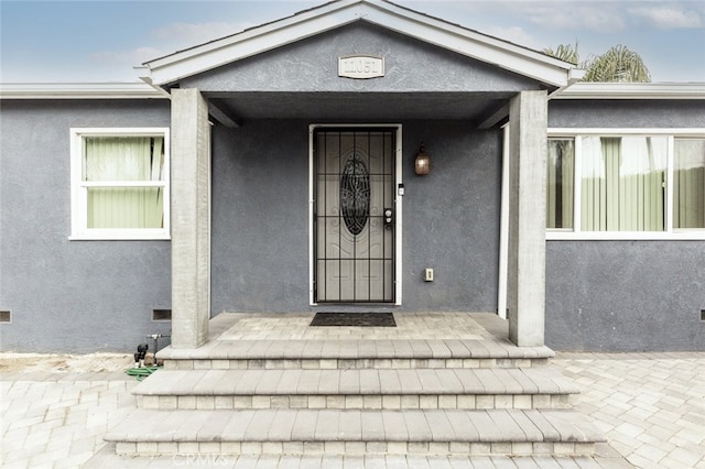 entrance to property featuring covered porch