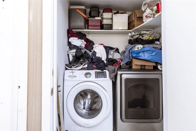 clothes washing area with washer and clothes dryer