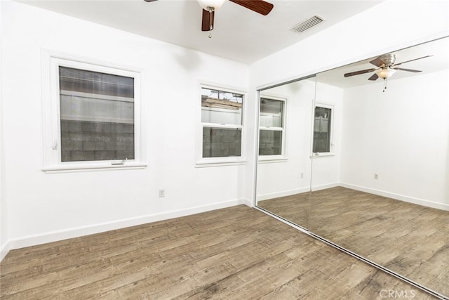 empty room featuring ceiling fan and wood-type flooring