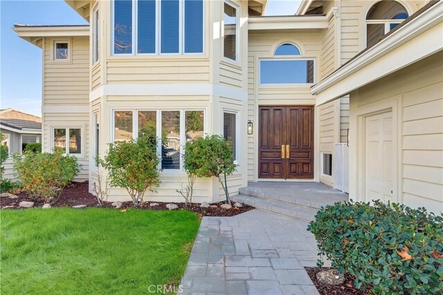 doorway to property with a yard