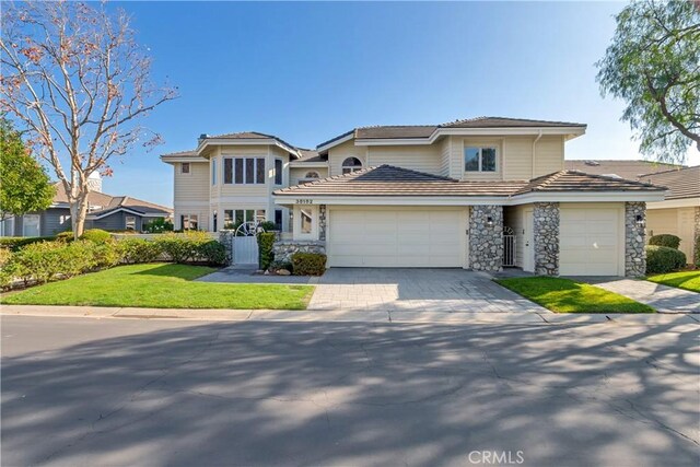 view of front of home with a front lawn and a garage