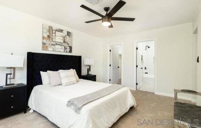 carpeted bedroom with ensuite bathroom and ceiling fan