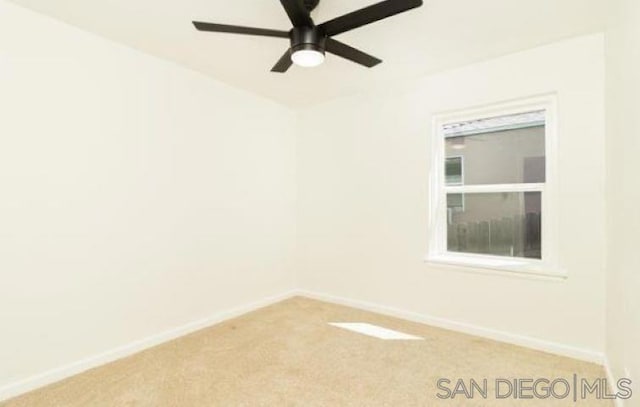 spare room featuring ceiling fan and light colored carpet