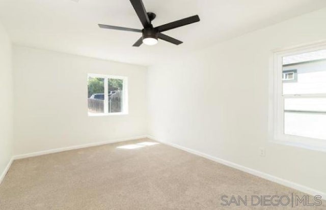 carpeted empty room featuring ceiling fan