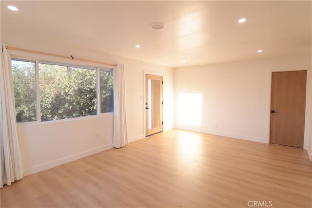 unfurnished room featuring light hardwood / wood-style floors