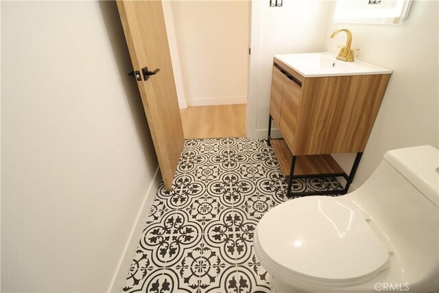 bathroom featuring toilet and vanity