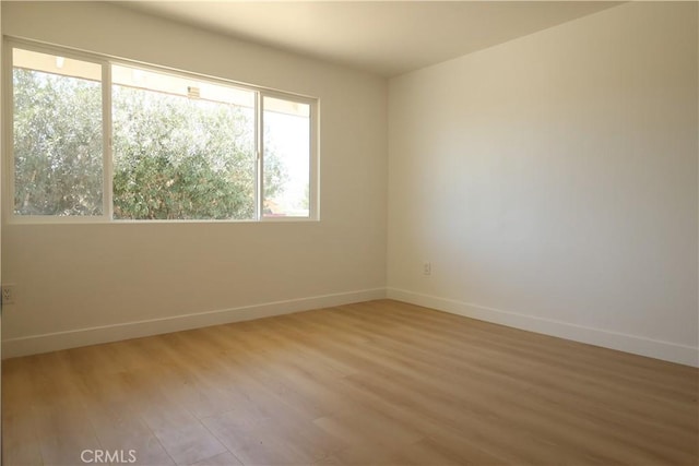 empty room with hardwood / wood-style flooring