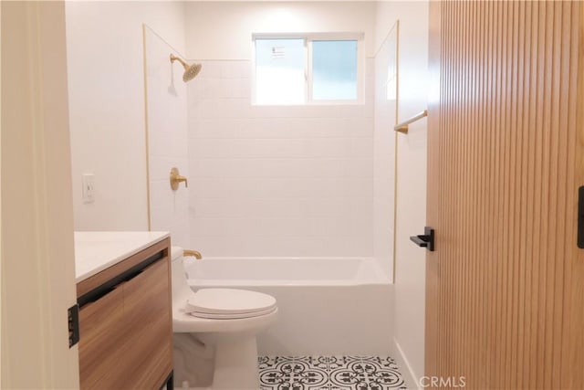 full bathroom featuring washtub / shower combination, toilet, vanity, and tile patterned flooring