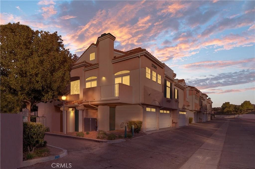 outdoor building at dusk featuring a garage