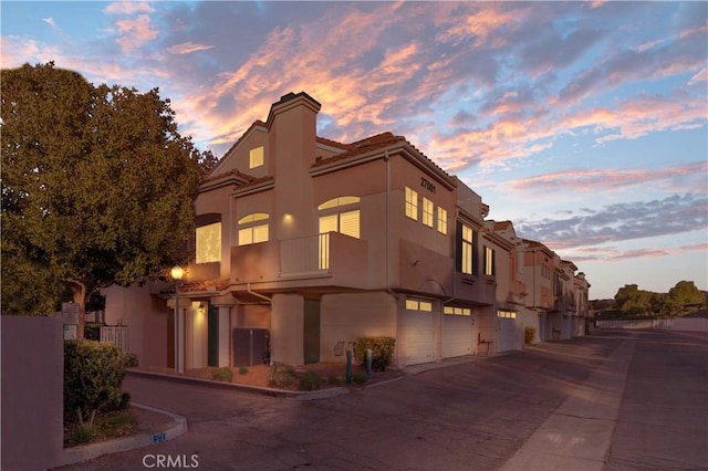 outdoor building at dusk featuring a garage