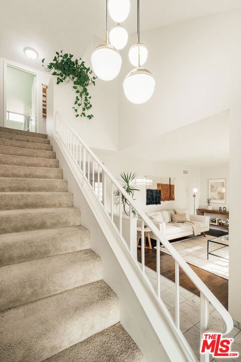 stairs featuring a towering ceiling