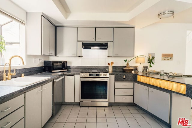 kitchen with ventilation hood, sink, gray cabinets, appliances with stainless steel finishes, and light tile patterned flooring