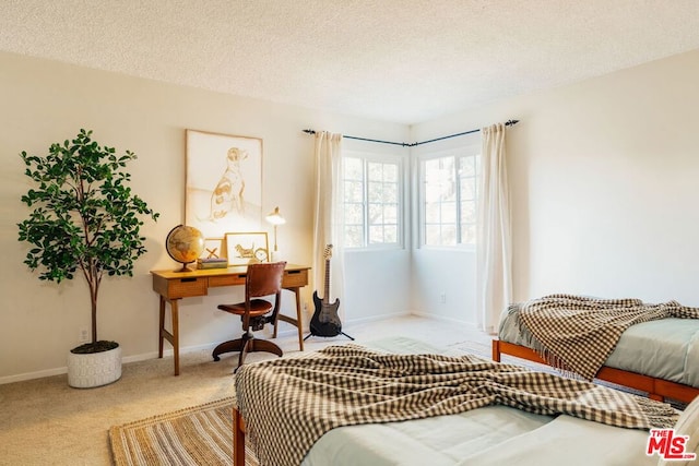 carpeted bedroom featuring a textured ceiling