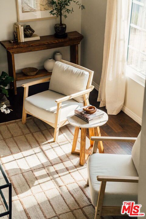 sitting room with hardwood / wood-style flooring