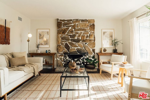 living room with a stone fireplace