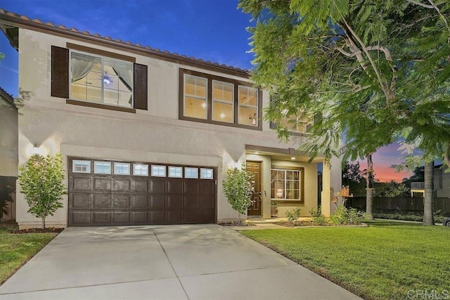 mediterranean / spanish house with a garage and a yard