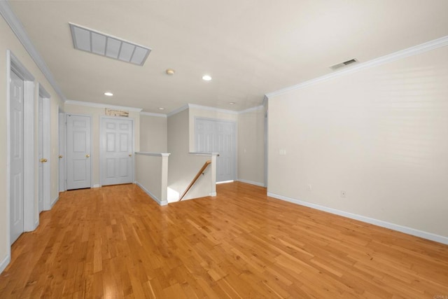 unfurnished room with crown molding and light hardwood / wood-style floors