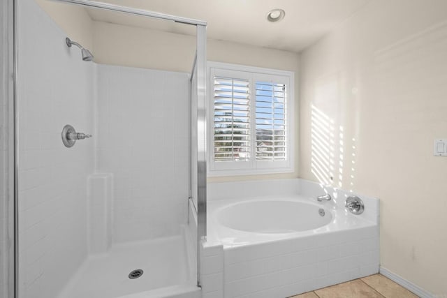 bathroom with separate shower and tub and tile patterned floors