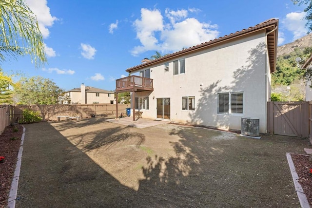 back of property with a patio, a balcony, and central air condition unit