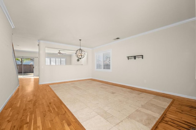 empty room with ornamental molding, light hardwood / wood-style floors, and a notable chandelier