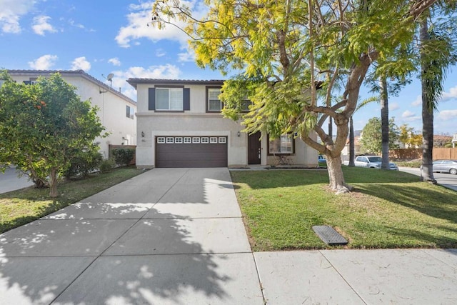 traditional-style house with an attached garage, driveway, a front lawn, and stucco siding