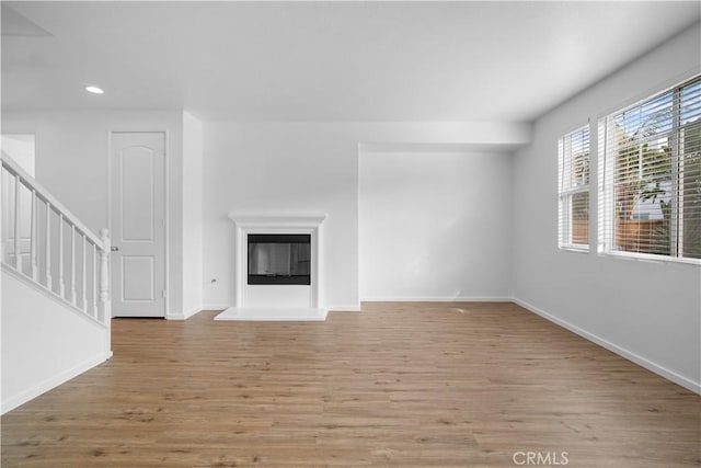 unfurnished living room featuring light hardwood / wood-style floors