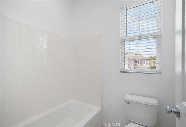 bathroom featuring toilet and shower / bathing tub combination