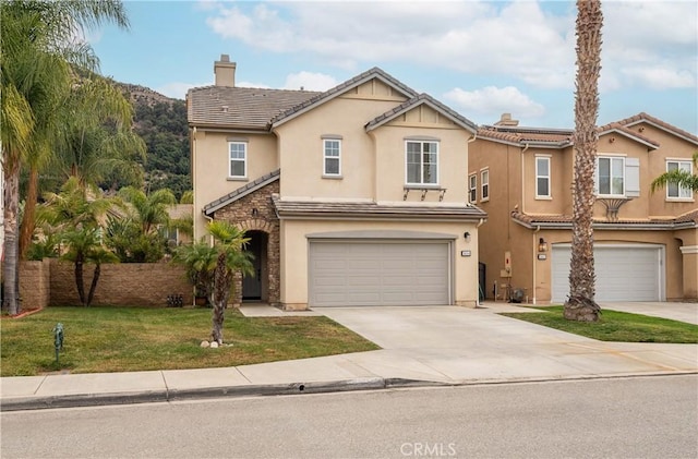 view of front of home with a front yard and a garage