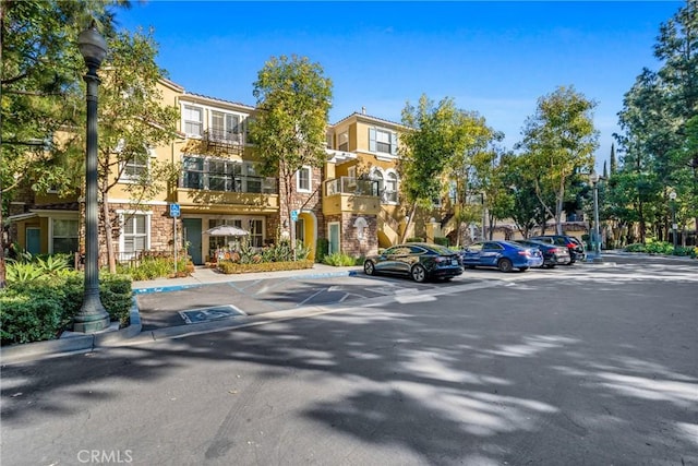 exterior space featuring sidewalks, street lighting, and curbs