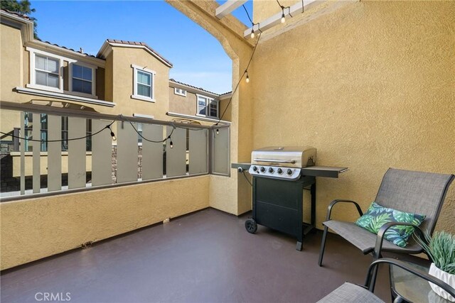 balcony with a grill and a pergola