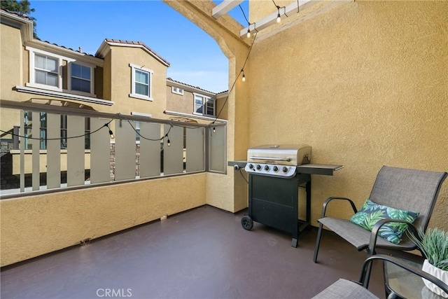 view of patio featuring a grill, a balcony, and a pergola