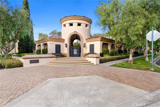 view of front of home with a tiled roof and stucco siding