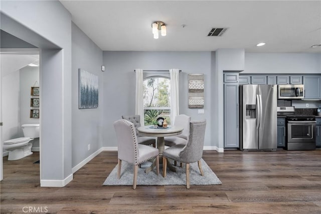 dining area with recessed lighting, visible vents, dark wood finished floors, and baseboards