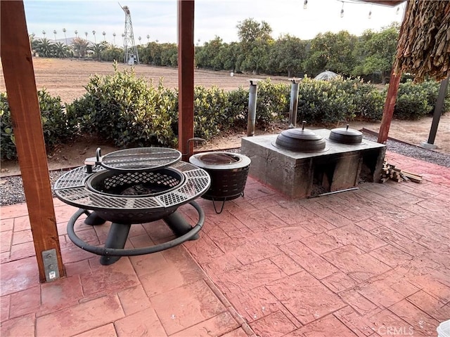 view of patio with an outdoor fire pit