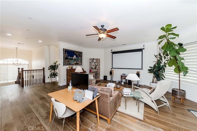 living room featuring crown molding, ceiling fan with notable chandelier, and hardwood / wood-style floors